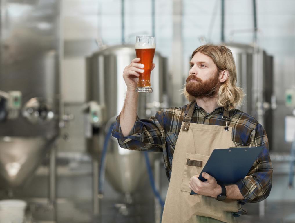 Bearded Man Holding Beer Glass at Brewery - distilleries in Augusta