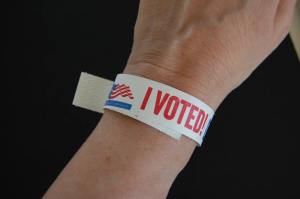 Election voter wears I voted did you bracelet wristband after early voting in Presidential Primary political race in the City of Chicago USA